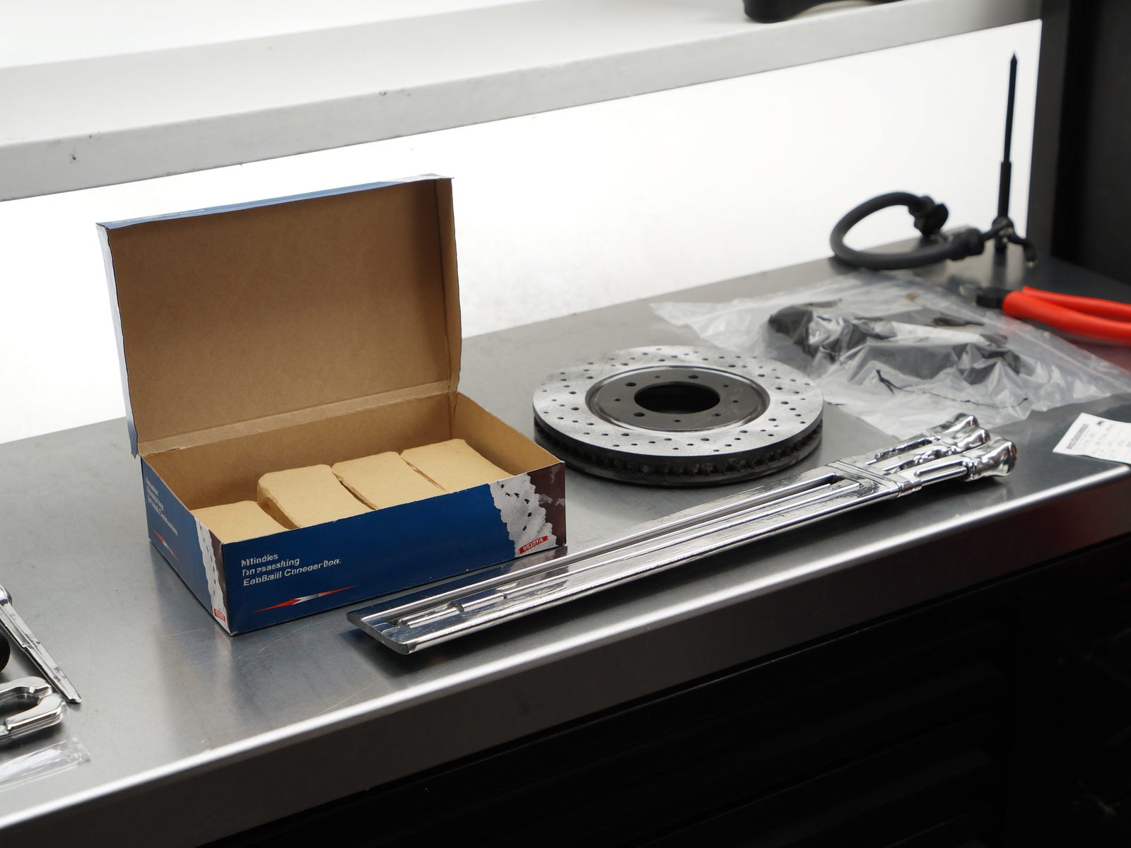 A workbench with brake pads, a rotor and a torque wrench