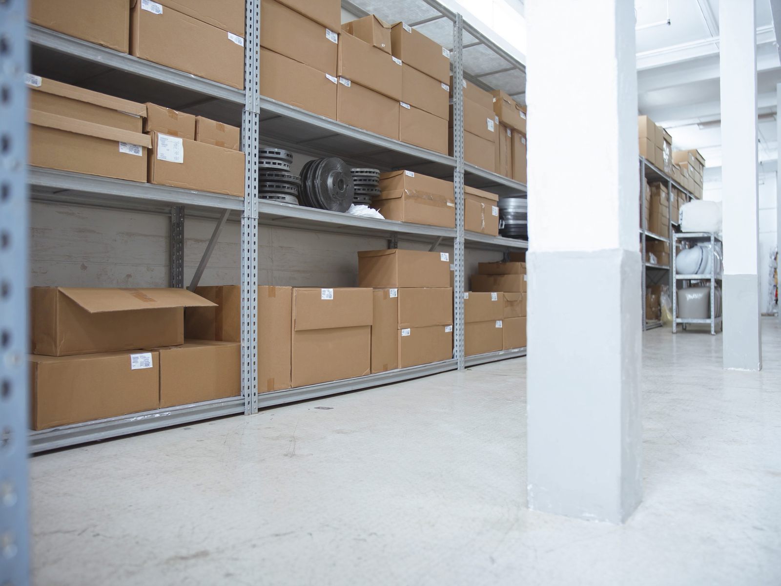 Shelves of boxed parts in an auto shop