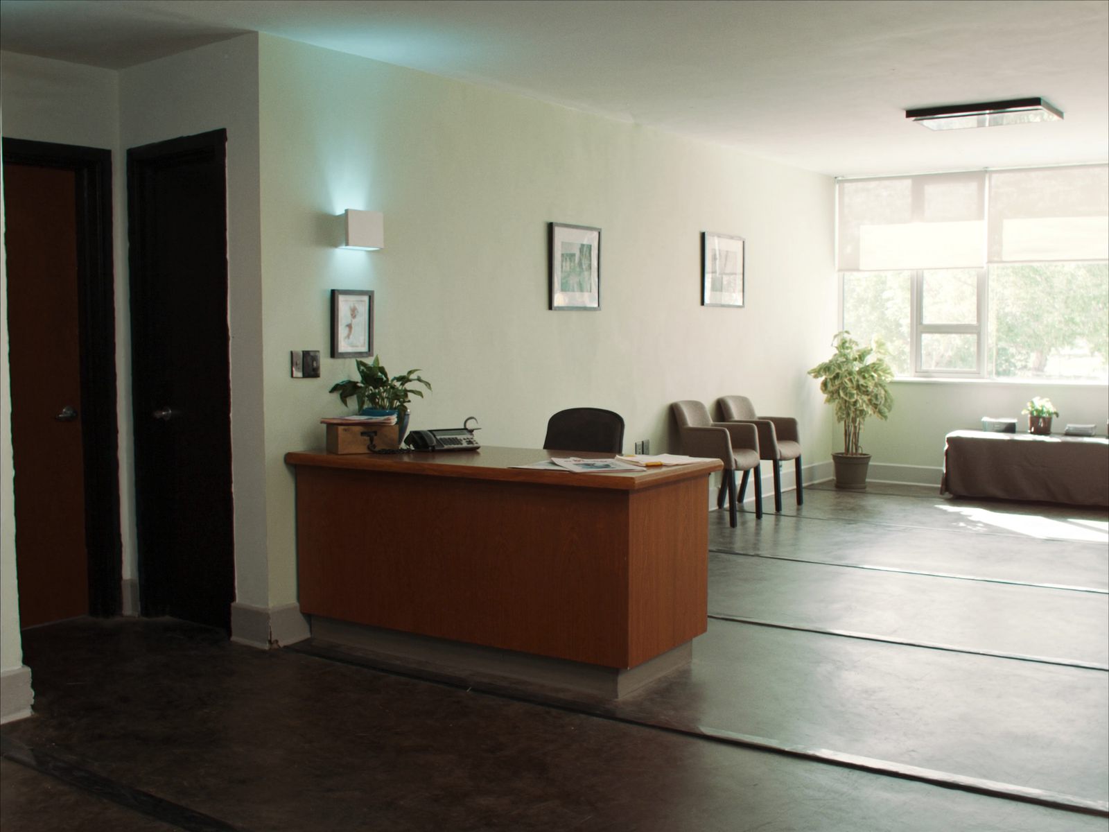 A clinic reception with a wooden front desk