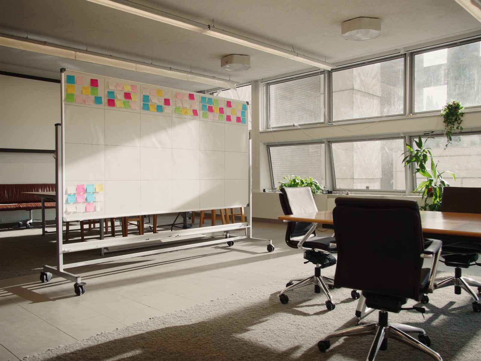 A meeting room with a whiteboard and sticky notes