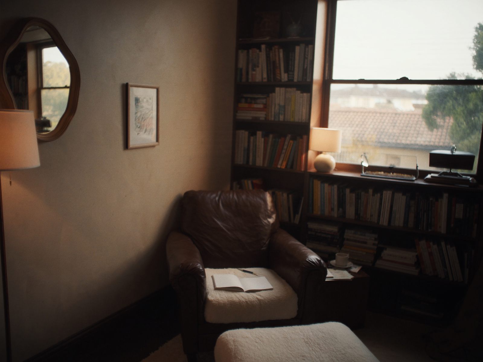 A reading corner with a leather armchair and bookshelf