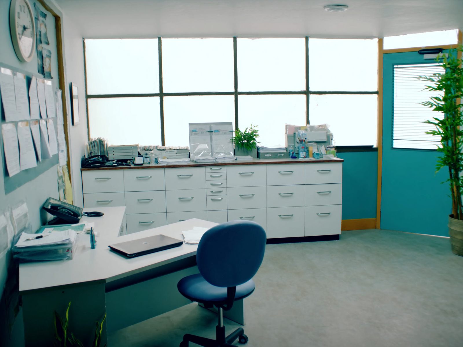 The back office of a dental practice with a desk and filing cabinets