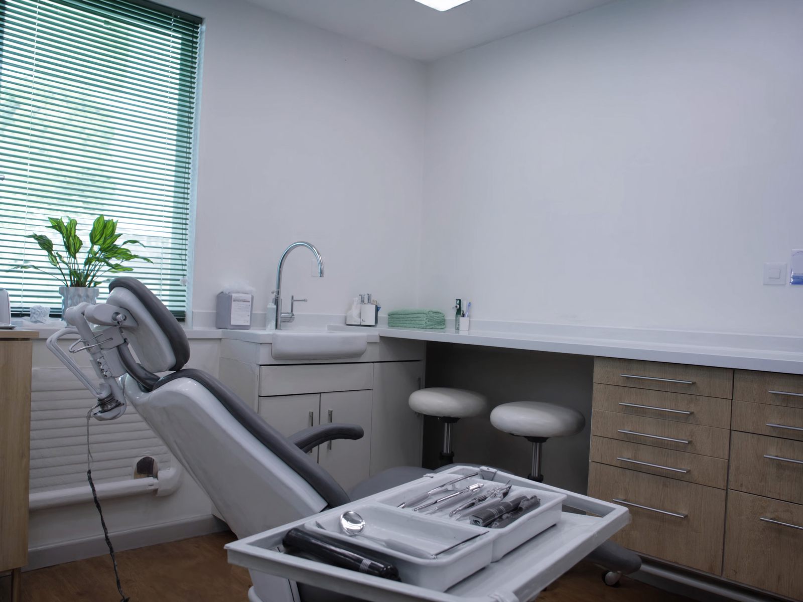 A dental hygiene room with an instrument tray in morning light