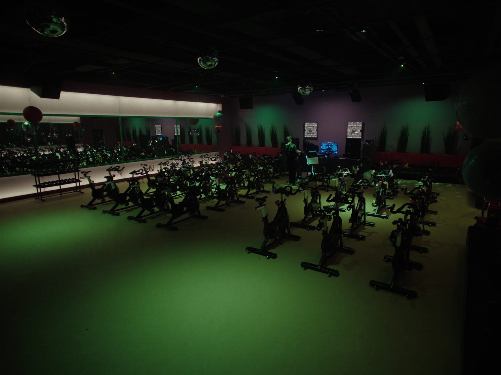 An indoor cycling studio with rows of bikes