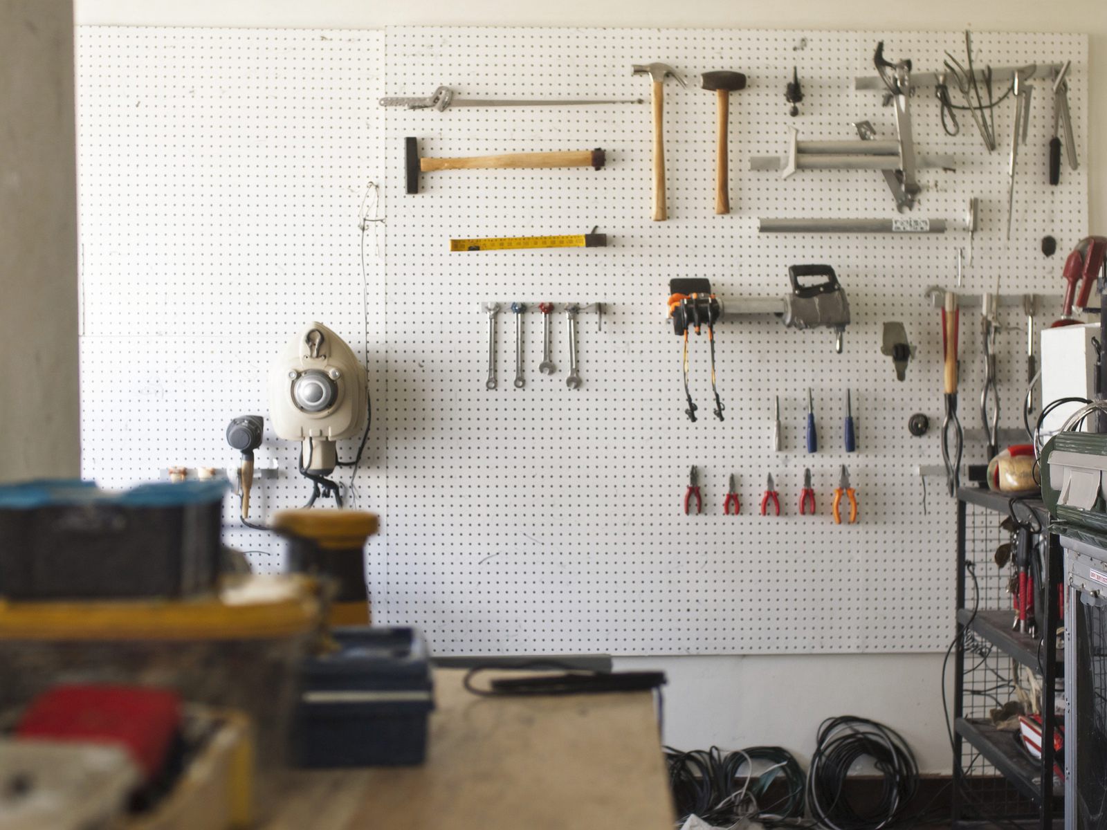 A pegboard tool wall in a workshop