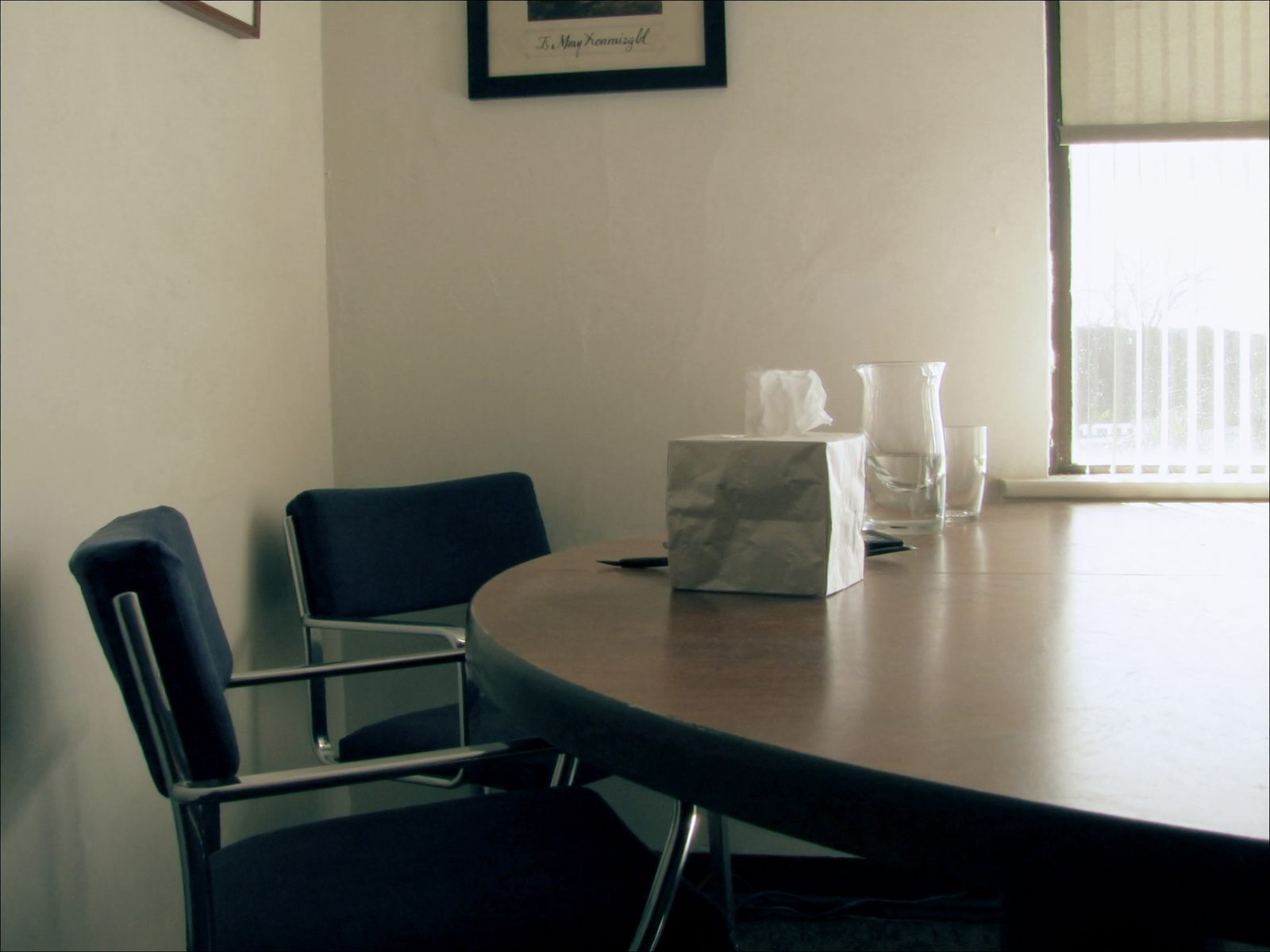 A private consultation room with two chairs at a round table