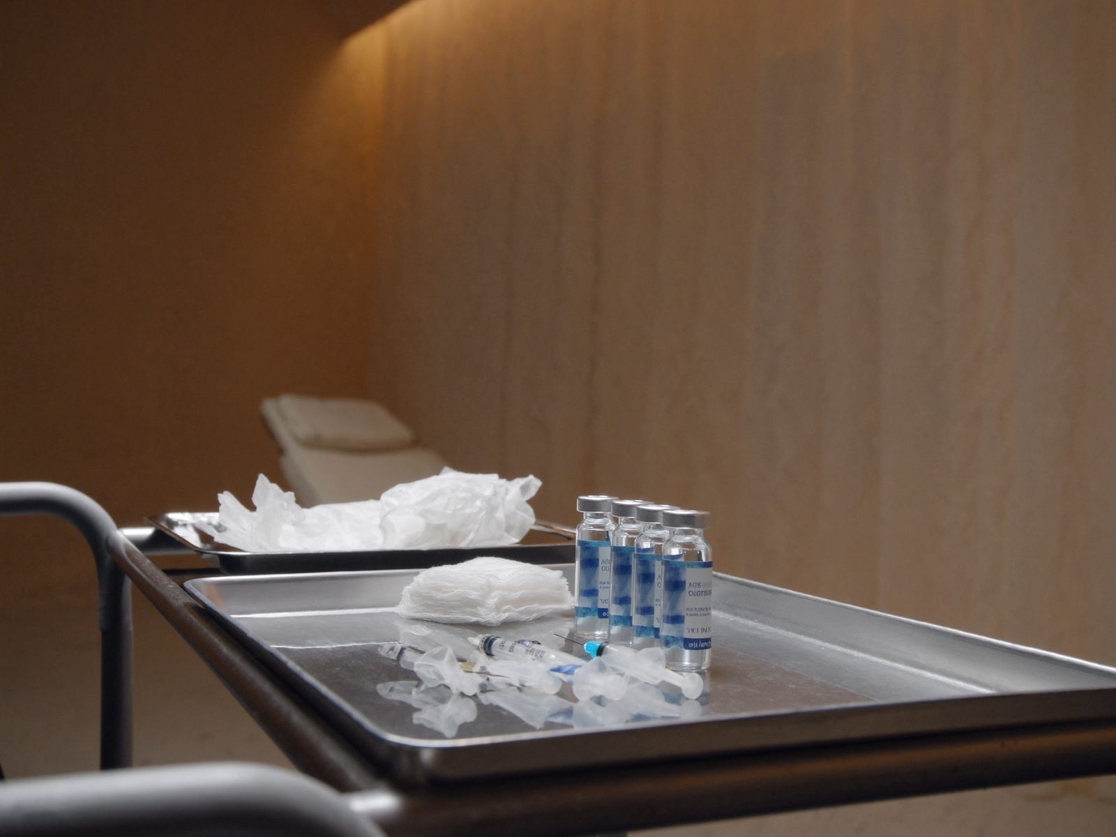 An aesthetics treatment cart with a sterile tray and small vials