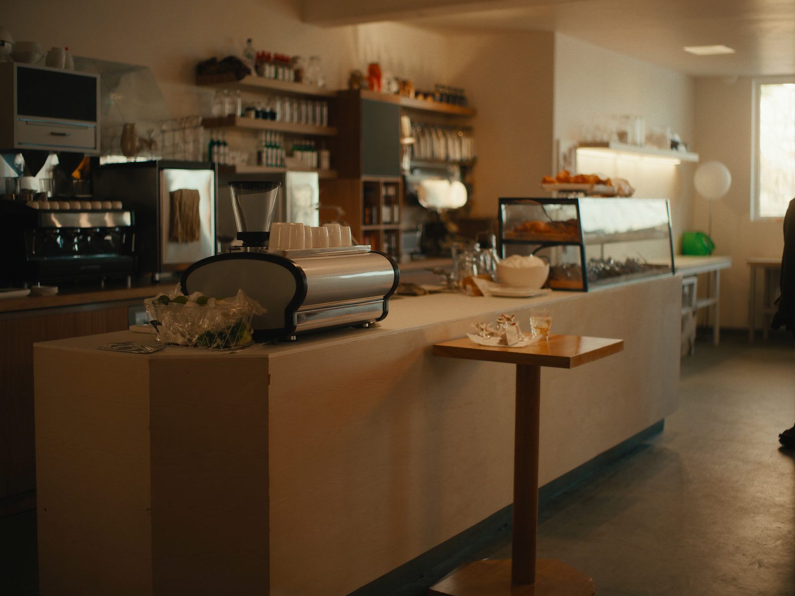 A cafe counter with pastries and an espresso machine