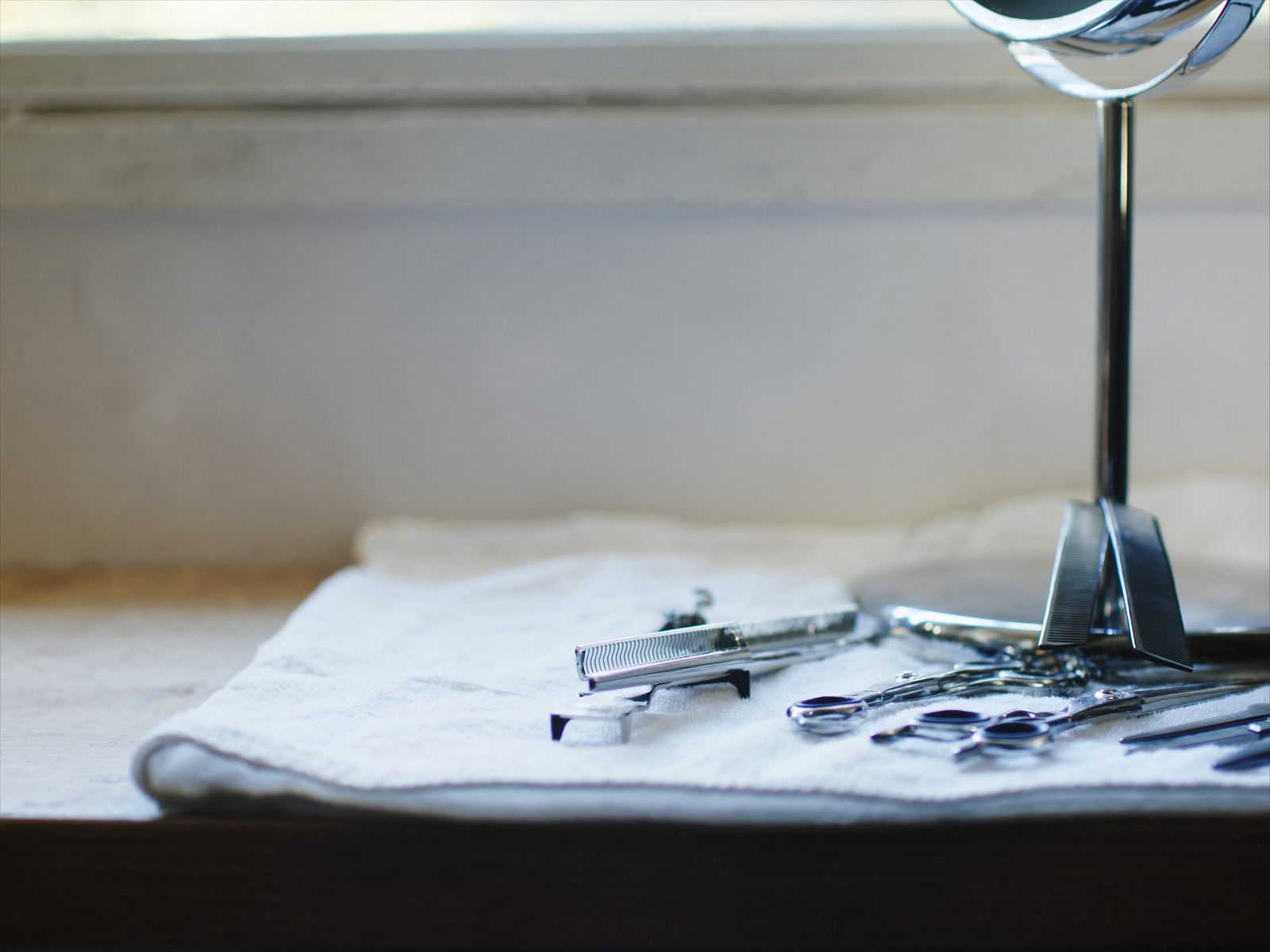 Clippers, combs and scissors laid out at a barber station