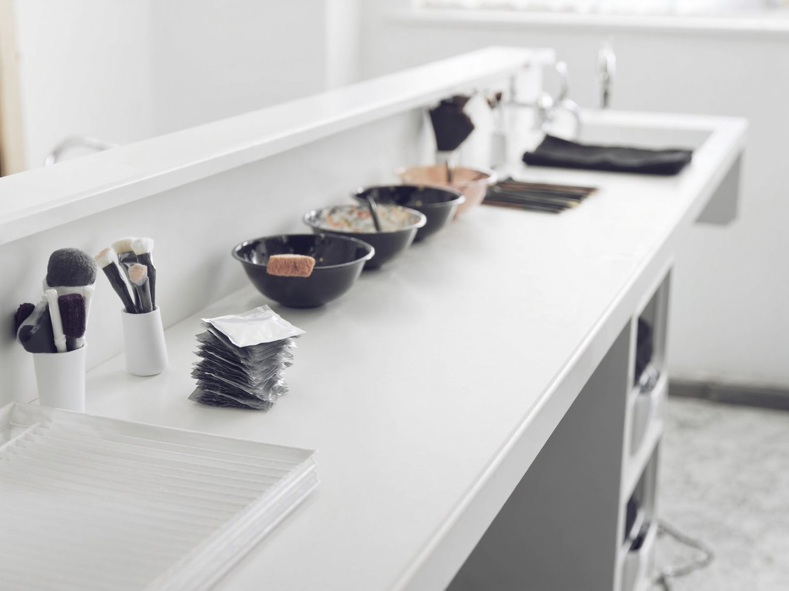 Hair color bowls and brushes on a counter