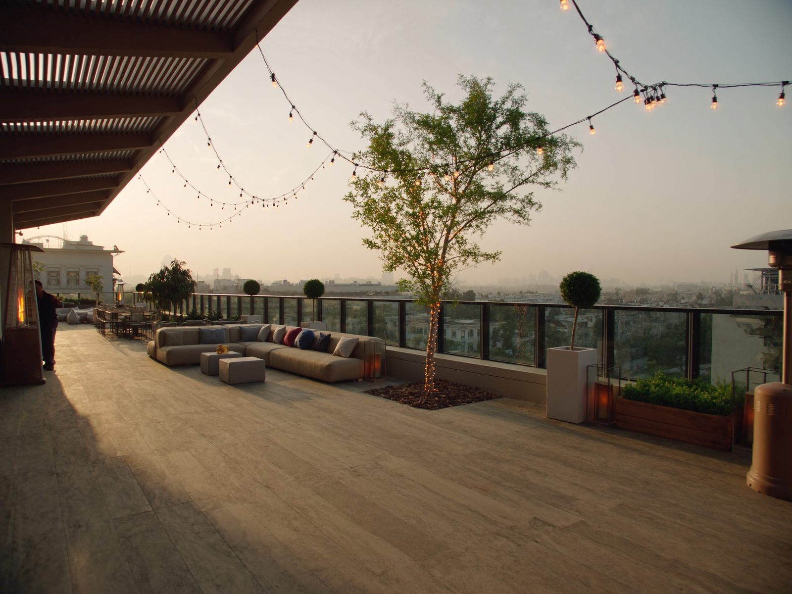 A venue terrace lounge with string lights at golden hour